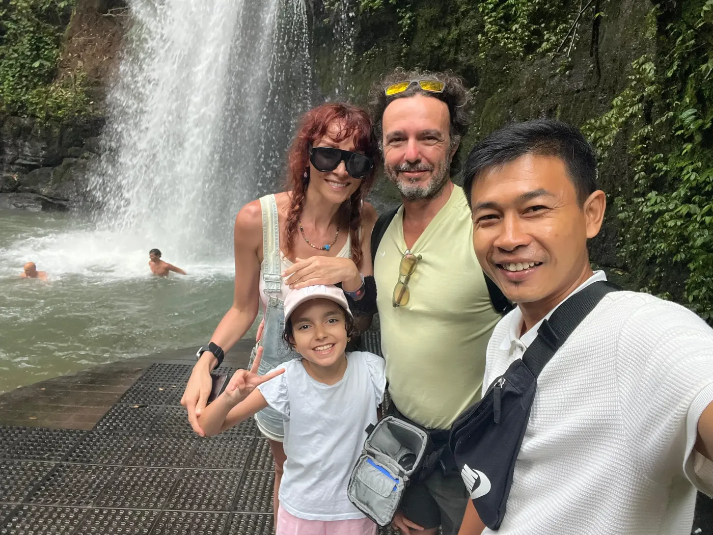 Eka and a family at a Bali waterfall